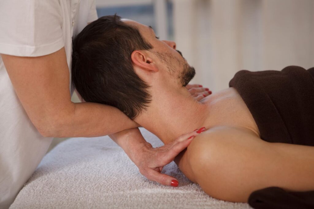 A therapist performing neck massage